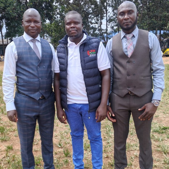 The Digilive Solutions director standing with two Sub-county Co-operative Officers, one for Mt Elgon and one for Sirisia